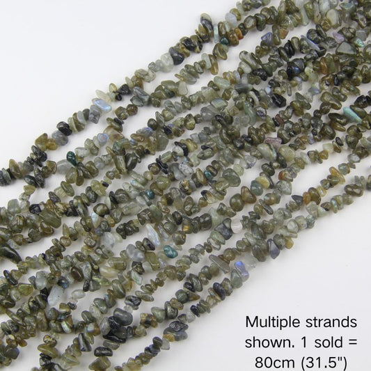 Multiple strands of natural labradorite chips with blue and green iridescent flashes, 31.5 inch beaded cord. 1 sold equals 1 strand (80cm).