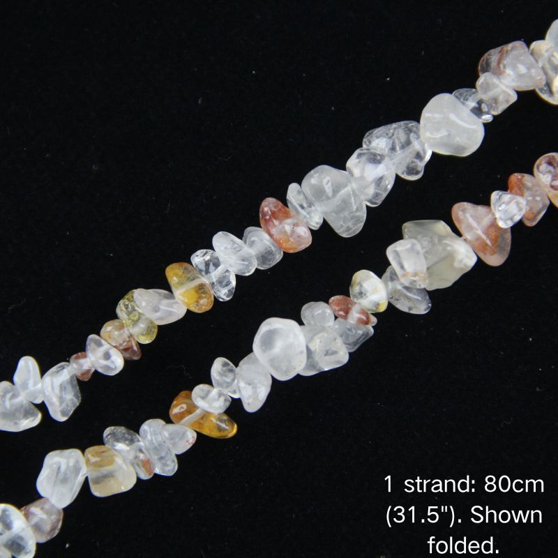 Macro close-up of light red hematoid quartz chip beads, 5-8mm polished chips, glossy finish.