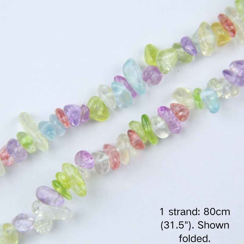 Macro close-up of glossy mixed colorful 5-8mm irregular glass chip beads, showcasing the polished texture, translucency, and center-drilled holes.