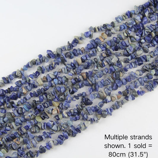 Multiple strands of natural mixed blue gemstone chips, deep blue with cream and earthy tones, 31.5 inch beaded cord. 1 sold equals 1 strand.