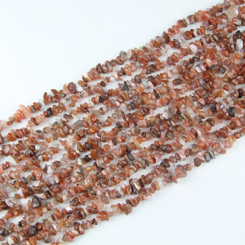 Natural red agate irregular bead long necklace on white background, deep red to crimson colors on each freeform round bead