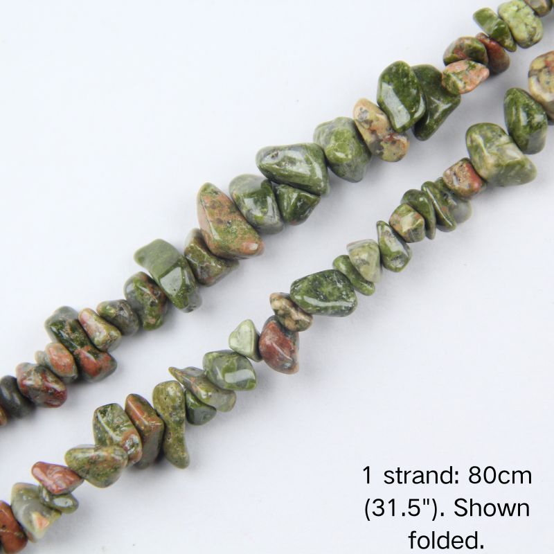 Close-up detail of natural spiderweb howlite chip beads showing 5-8mm irregular nuggets with creamy white base and dark natural veins.
