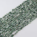 Natural tree agate irregular bead long necklace on white background, milky white beads with black and deep green dendritic tree-like patterns on each freeform bead