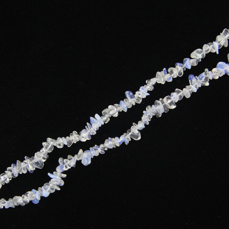 Single irregular opalite bead necklace laid flat on light surface, 31-inch strand with smooth glassy white-blue beads