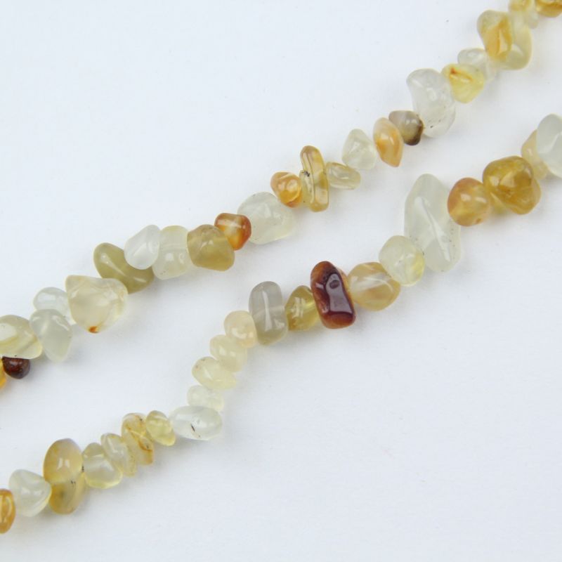 Close-up of irregular orange agate beads, uneven round surface and natural banding visible in each bead