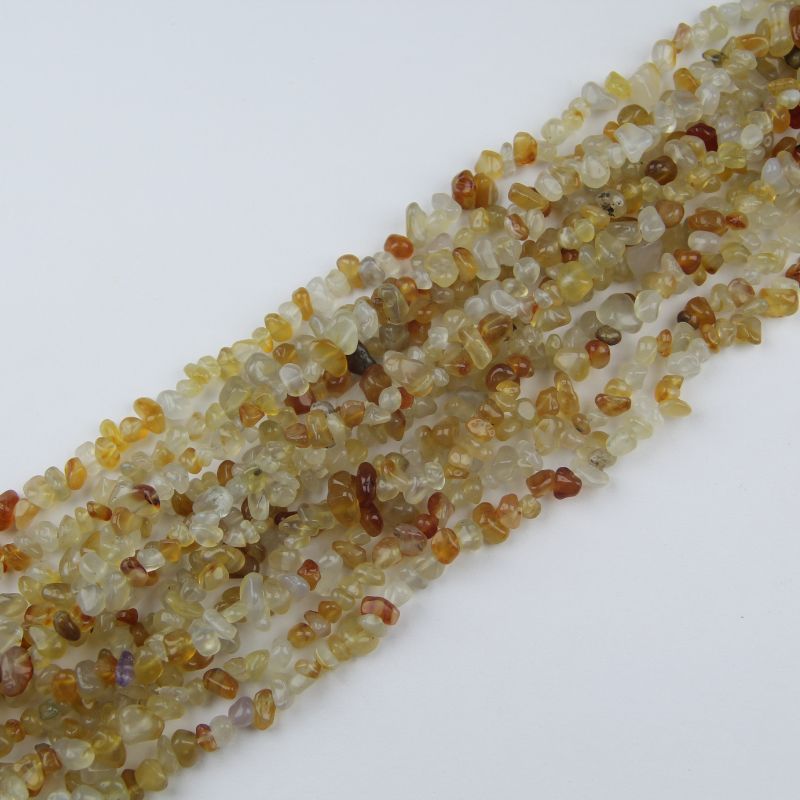 Multiple orange agate irregular bead bracelets stacked together, showing variation in bead shape and color intensity