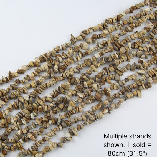 Multiple strands of natural picture jasper chips, earthy cream and brown stones with organic speckles, 31.5 inch beaded cord. 1 sold equals 1 strand.