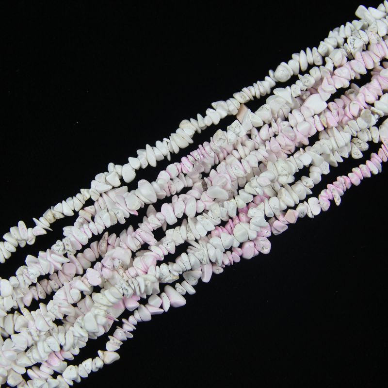 stacked coils of pink and white blossom howlite bead strand, 31.5 inches long, irregular round 5-8mm beads with pink crackle pattern on nylon cord