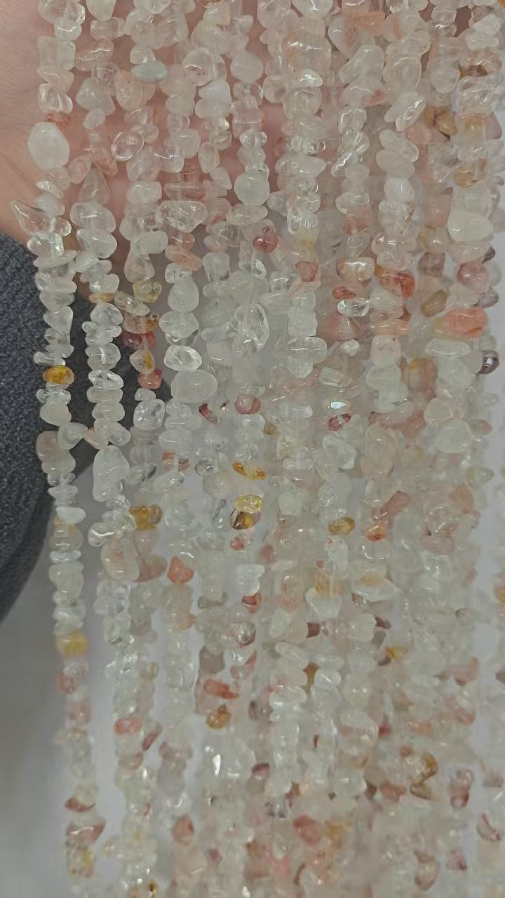 light pink floral inclusion quartz long bead chain hanging naturally showing soft pink flower patterns and gentle drape against white background