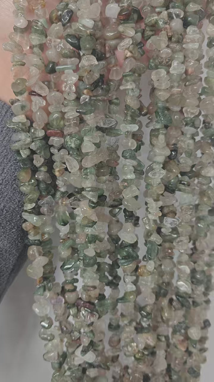 360-degree rotation video of natural green rutilated quartz (actinolite quartz) beaded long necklace, close up of the layered green inclusions detail 
