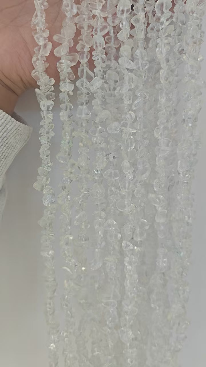 Wearing demo of minimalist white glass beaded necklace. Shows the clean frosted/transparent texture of 5-8mm irregular white glass beads for everyday layering. 