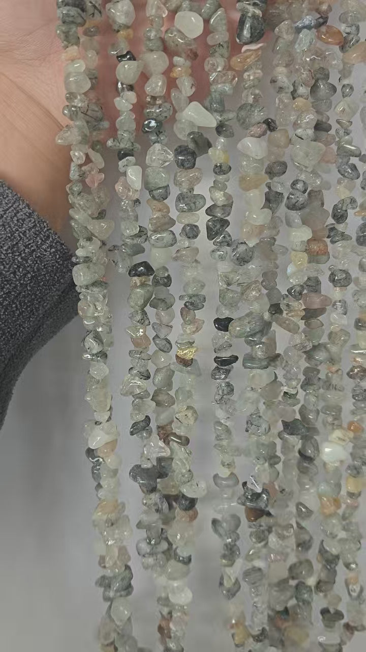 video demo of 31.5 inch natural black rutilated quartz long beaded necklace, turning to show the deep black needle inclusions under natural daylight