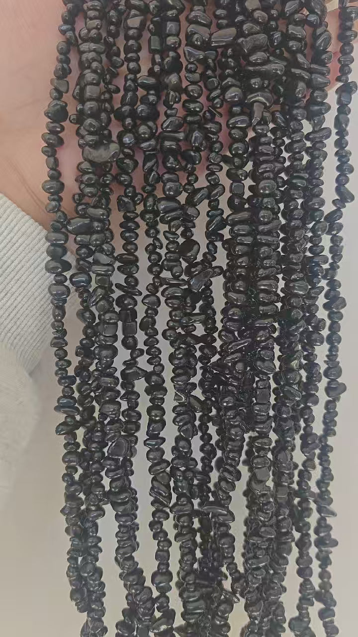 Black obsidian long bead chain showing natural drape and flow movement when lifted