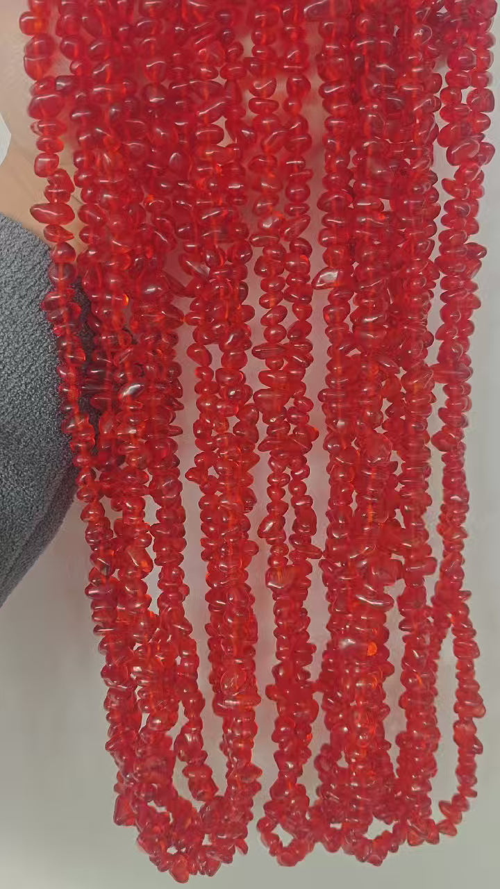 Full view of bold red glass long necklace. Demonstrates how the deep warm tone and texture of 5-8mm irregular red glass complement winter and autumn outfits. 