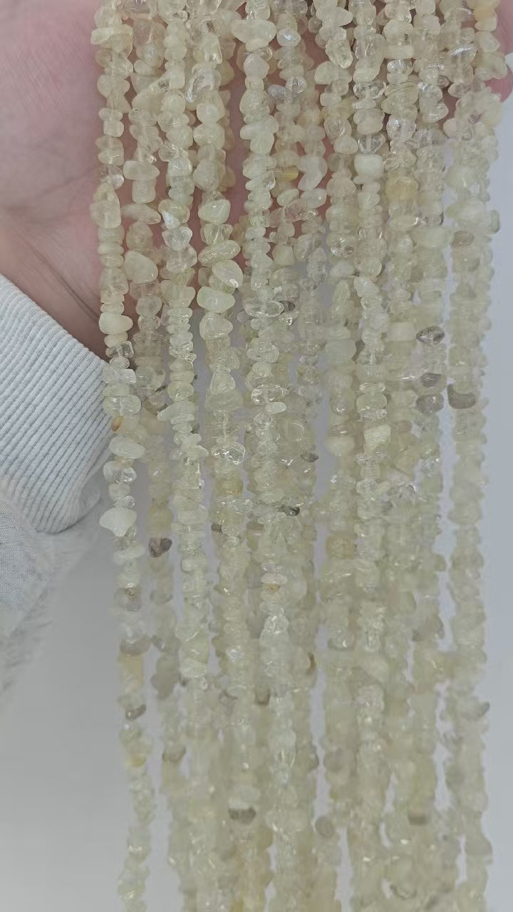 Video showing multiple strands of natural yellow citrine beads, each 31.5 inches long, featuring 5-8mm irregular round beads threaded on durable nylon cord. Strands are displayed hanging to highlight sunny golden color, translucency, and length.