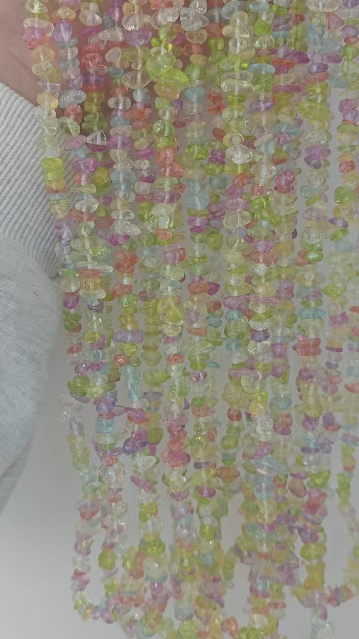Rotating showcase of mixed color irregular glass beaded necklace. Displays the varied translucent hues of 5-8mm multi-color glass beads and the 31.5-inch overall length. 