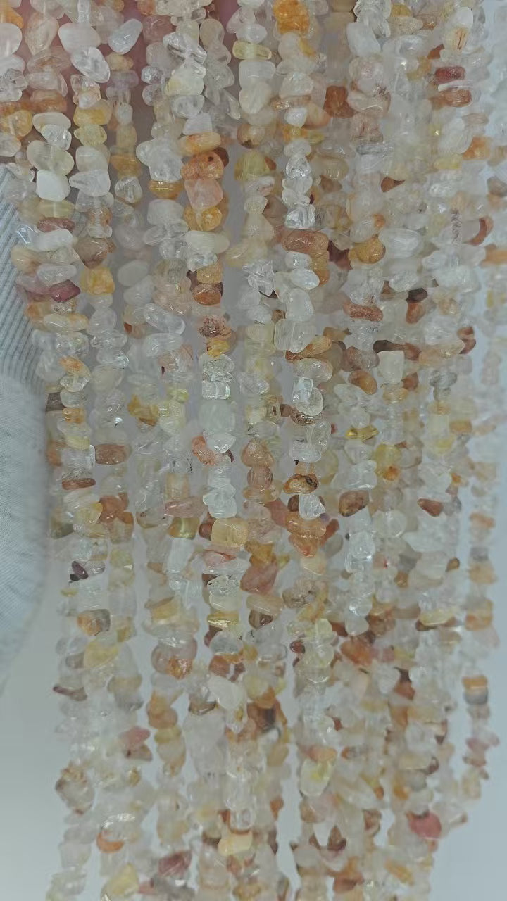 yellow floral inclusion quartz long bead chain showing natural drape and flow movement when lifted with golden inclusions shimmering in light