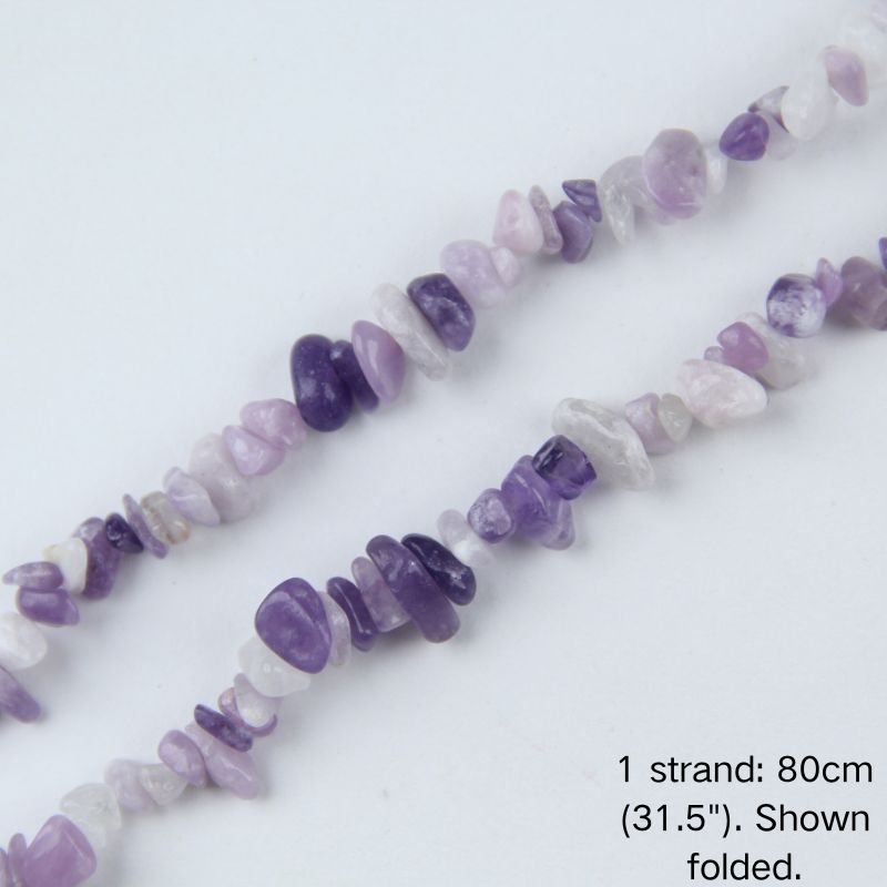 Macro close-up of purple lilac quartz chip beads, 5-8mm polished irregular chips with soft pastel color.