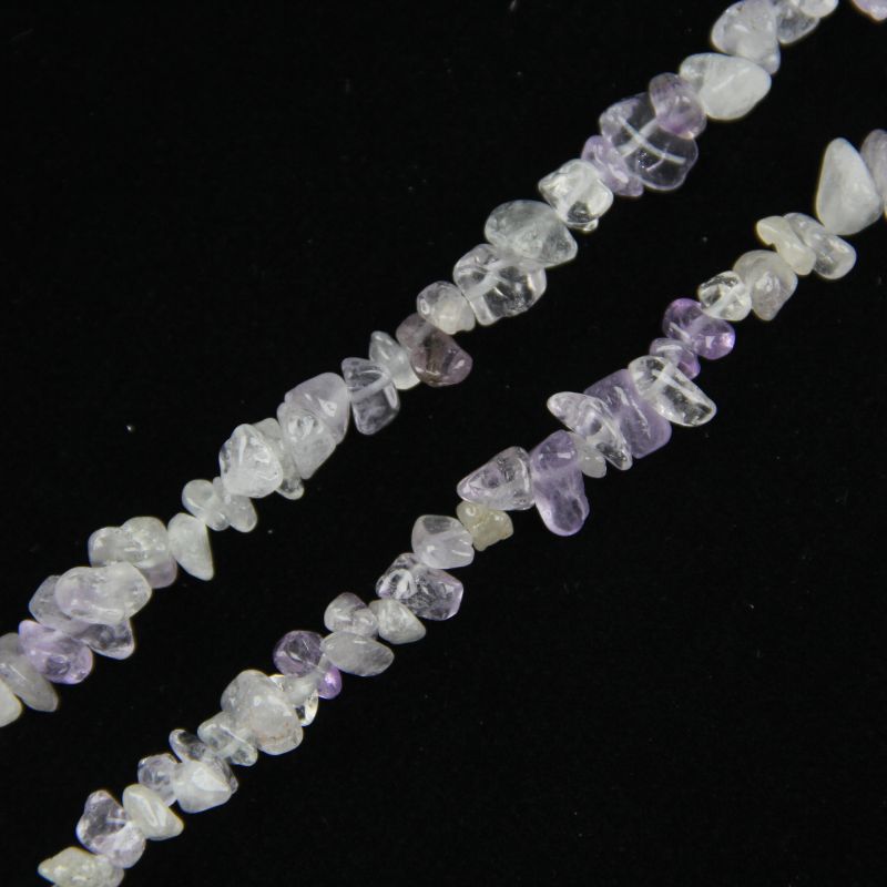 close-up of purple white crystal irregular round beads showing lavender and white color mix and nylon cord stringing, 5-8mm size