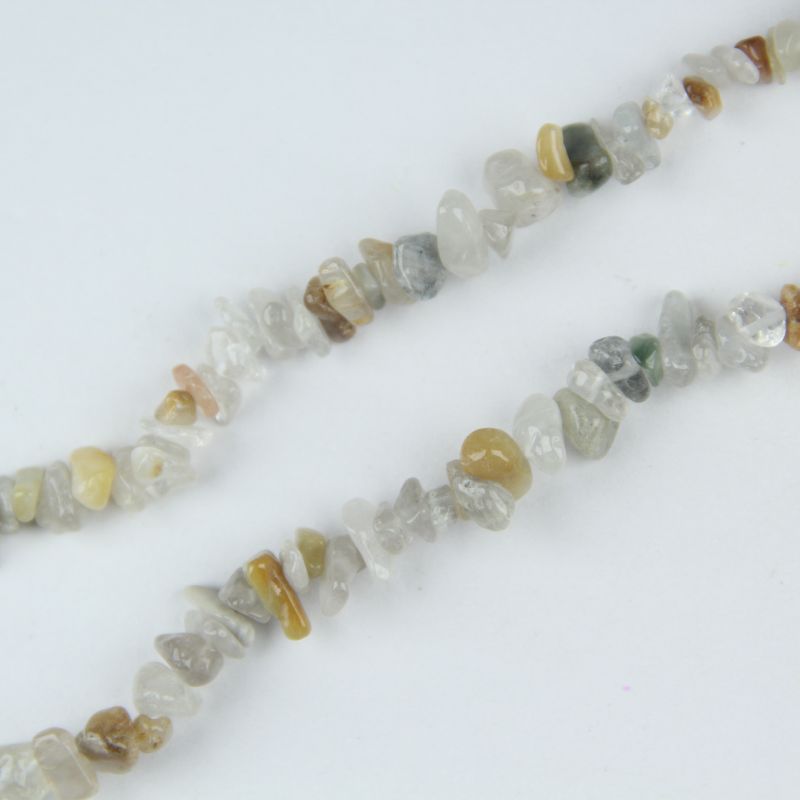 Macro close up of 5-8mm colorful rabbit hair crystal chips, showing delicate hair-like rutilated inclusions and nylon cord stringing detail