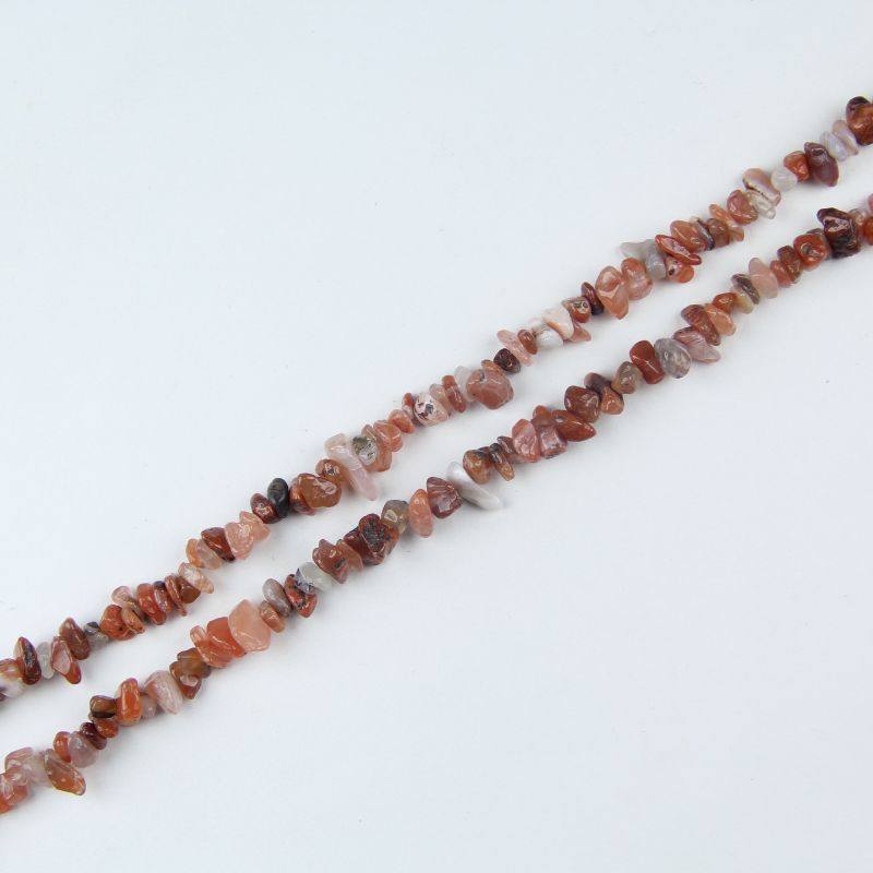 Single natural red agate irregular bead necklace laid flat on light surface, 31-inch length with organic round beads