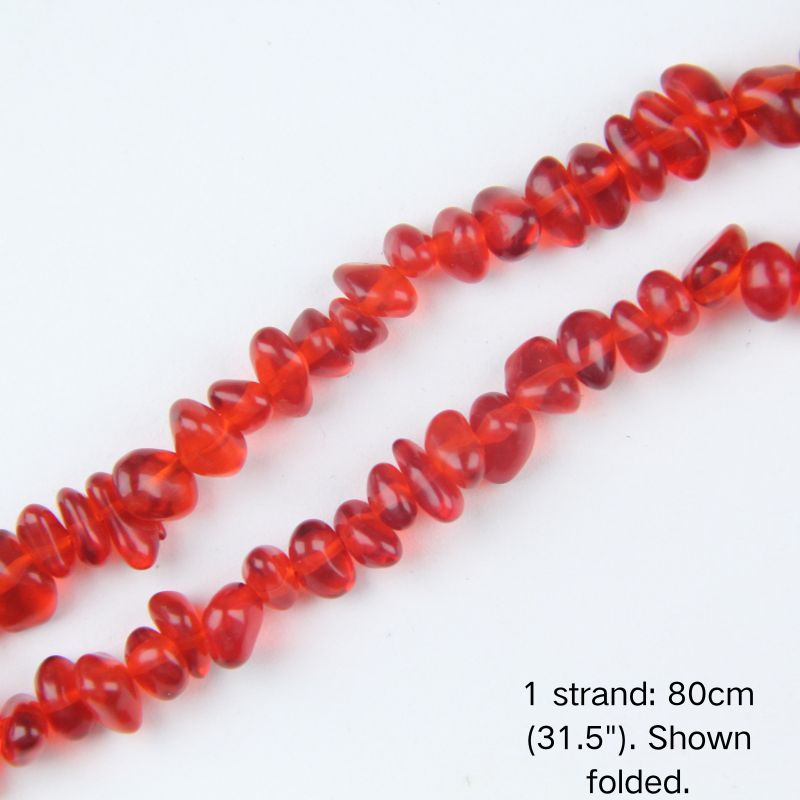 Macro close-up of glossy red 5-8mm irregular glass chip beads, showcasing the polished texture, translucency, and center-drilled holes.
