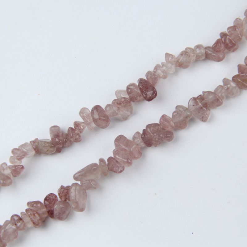 close-up of red strawberry quartz irregular round beads showing pinkish-red color and sparkly inclusions with nylon cord stringing, 5-8mm size