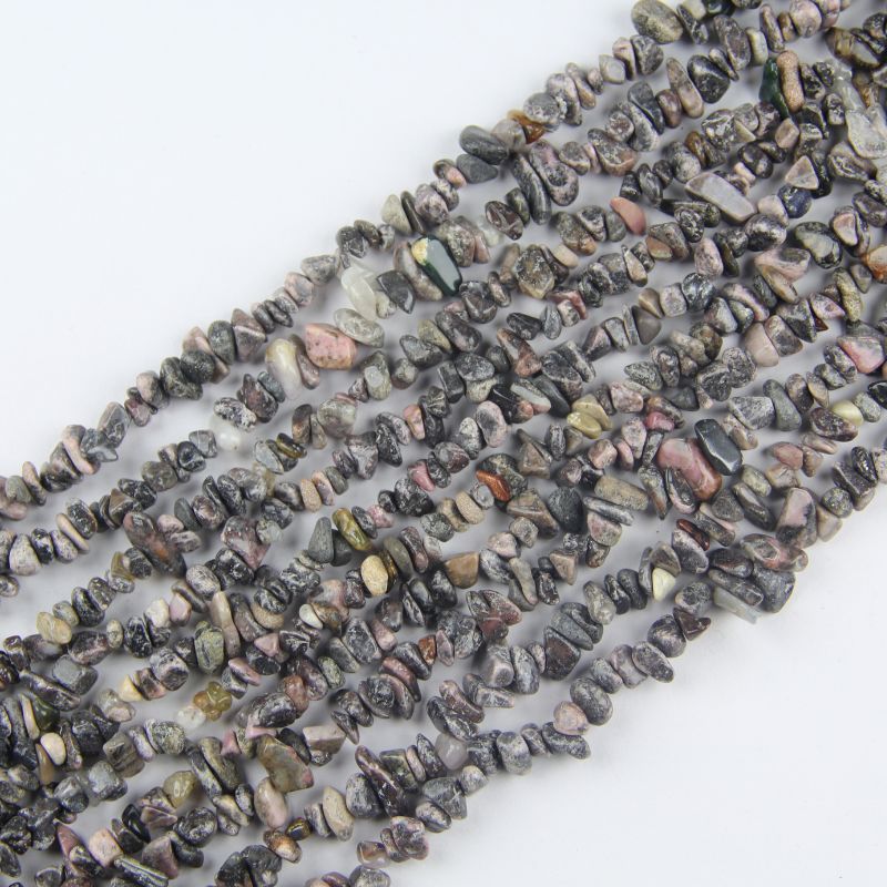 Red stripe agate irregular bead long necklace on white background, pink and deep red concentric wave patterns on each freeform bead