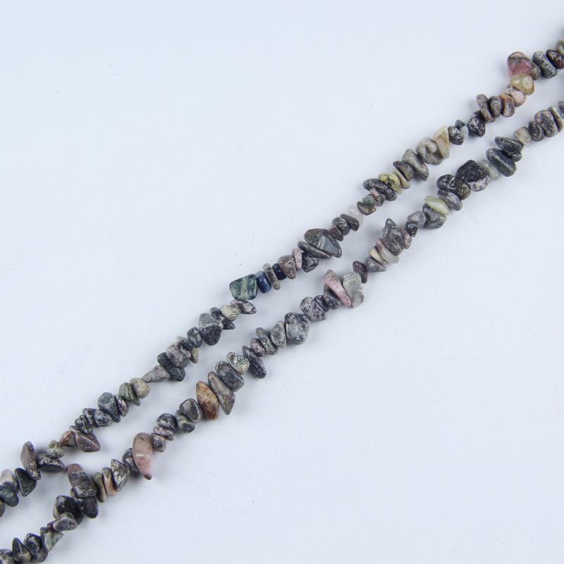 Single red stripe agate irregular bead necklace laid flat on linen, 31-inch length with organic round beads
