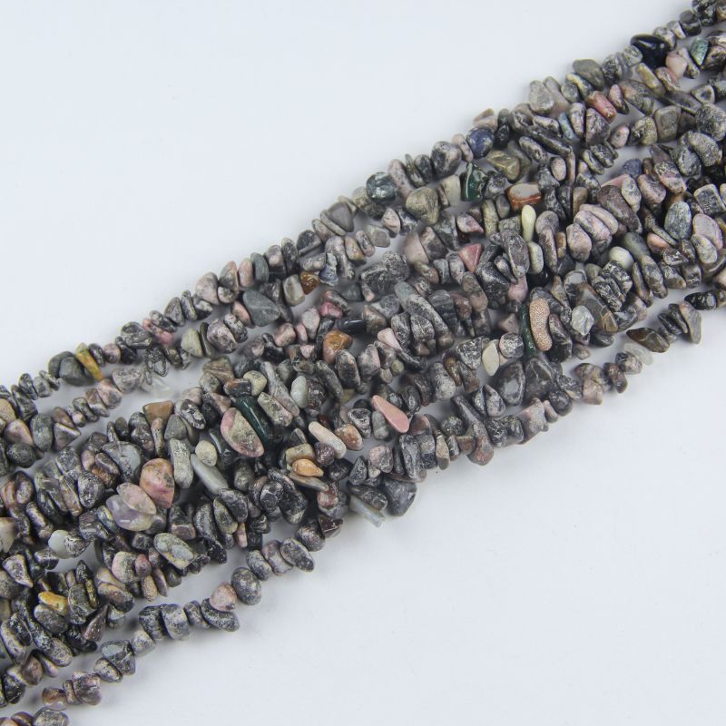 Multiple red stripe agate long necklaces stacked together, showing pink rose and crimson wave banding variations
