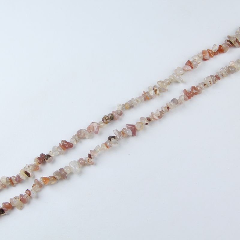 Single red white agate irregular bead necklace laid flat on linen, 31-inch length with organic round beads