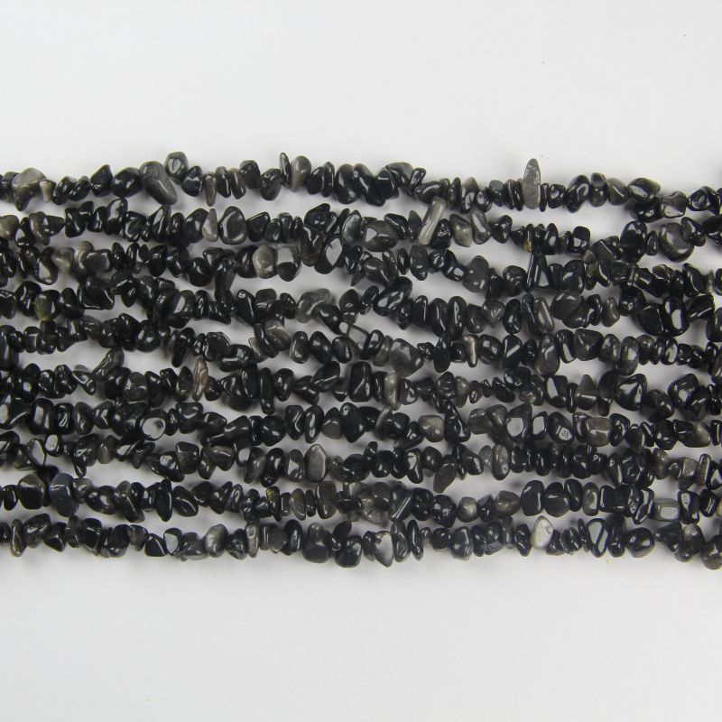closeup of irregular silver obsidian beads lined up showing 5 to 8mm size variation and subtle silver reflections