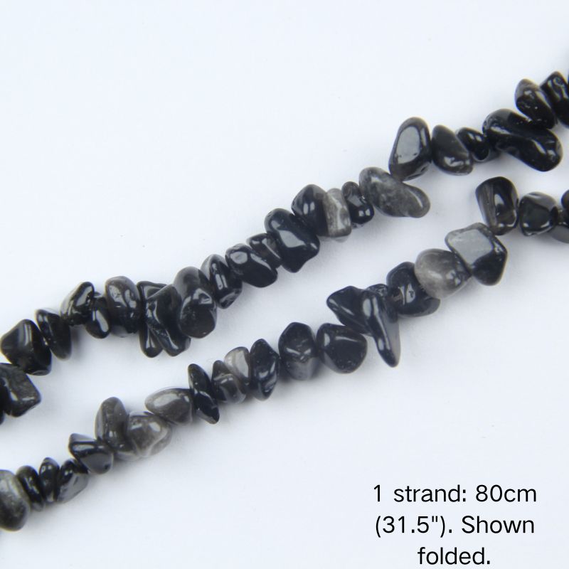 Macro close-up of silver obsidian chip beads showing smooth polish and 5-8mm irregular shape.