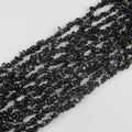 31.5 inch silver obsidian irregular bead necklace laid flat on white background showing subtle metallic silver sheen on black stone