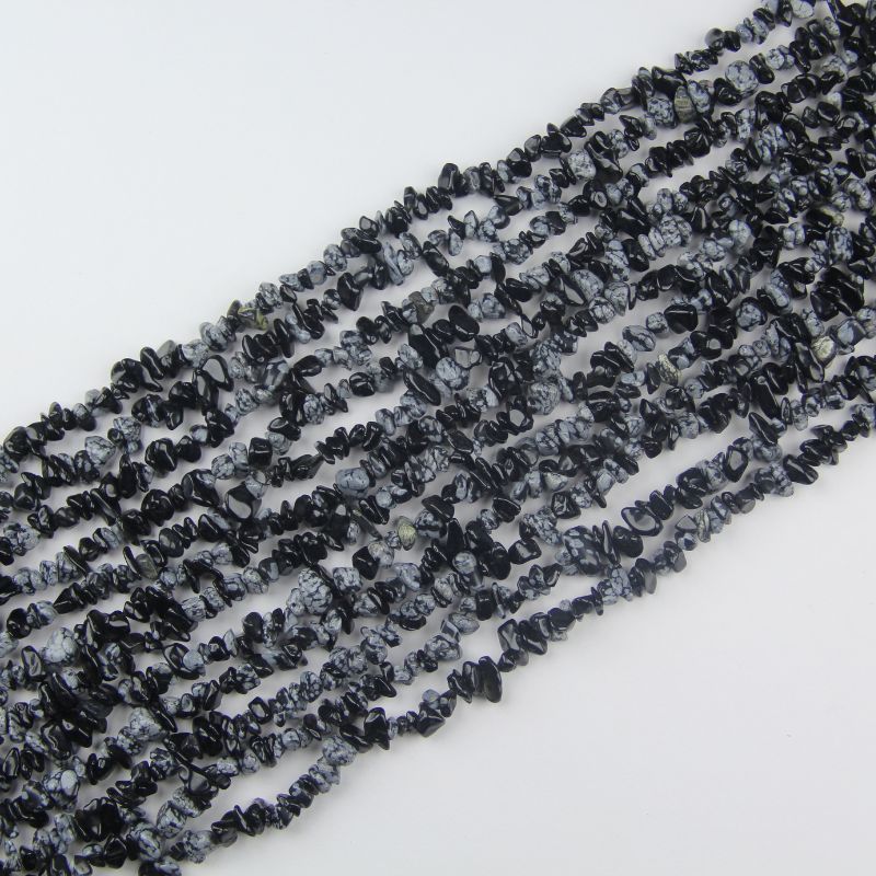 31.5 inch snowflake obsidian irregular bead necklace laid flat on white background showing white snowflake patterns
