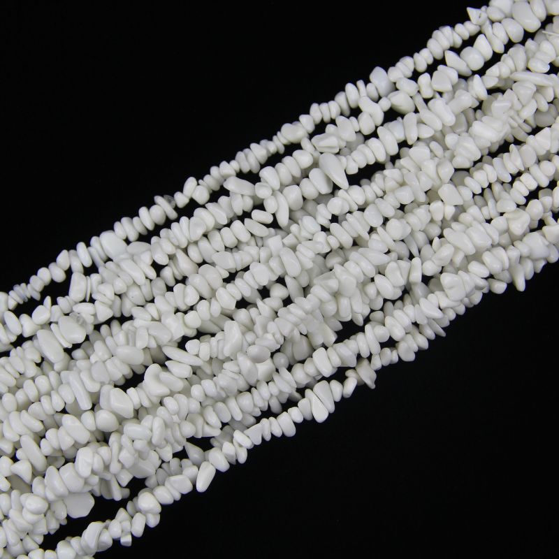 A stacked pile of several 31.5-inch long white porcelain bead chains, loosely piled to show volume and depth, irregular 5-8mm beads on nylon cord.