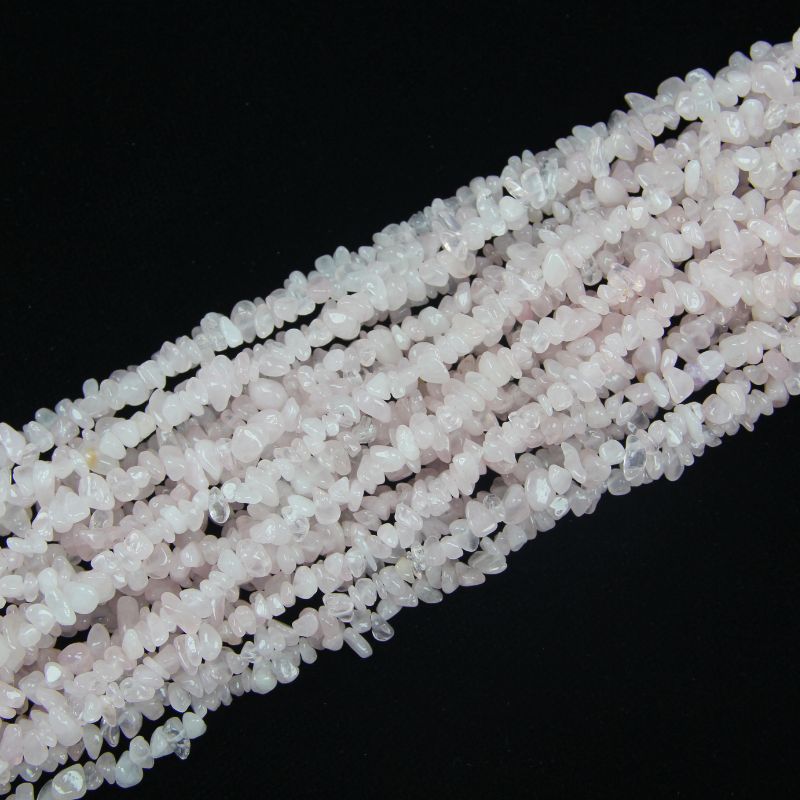 stacked coils of starry pink moissanite bead strand, 31.5 inches long, irregular round 5-8mm beads on nylon cord