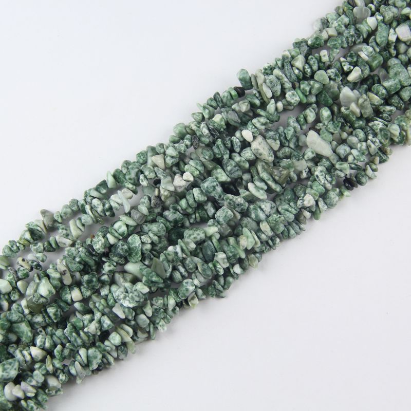 Multiple tree agate long necklaces stacked together, showing variation in dendritic patterns from tiny ferns to branch-like inclusions