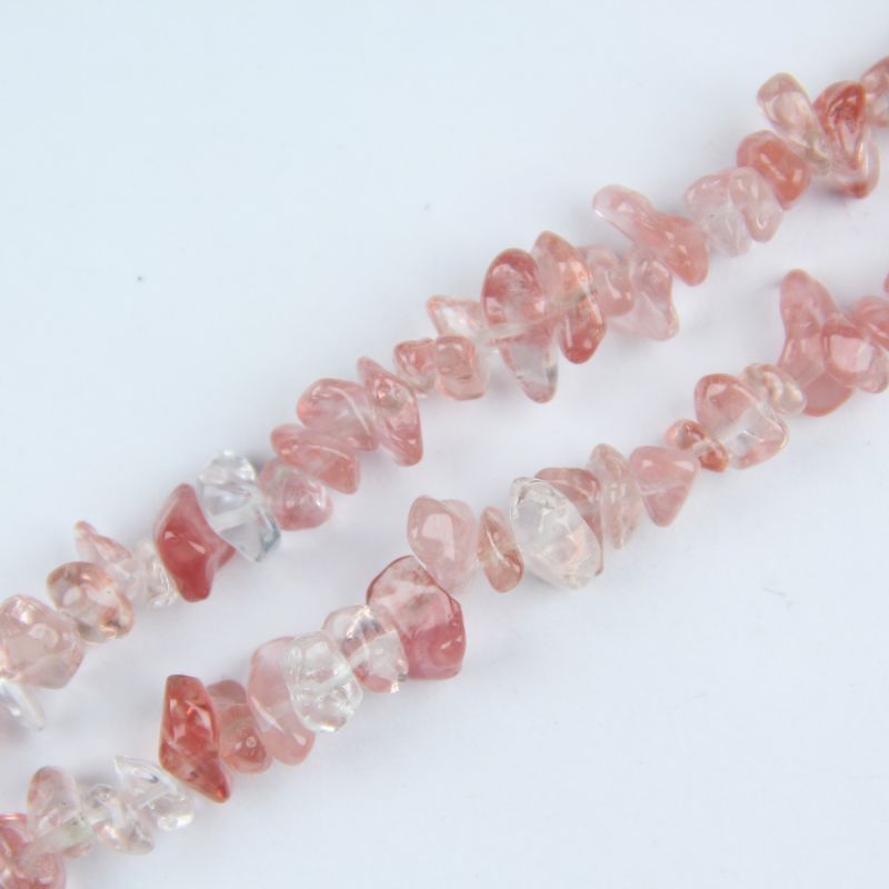 close-up of watermelon red crystal irregular round beads showing pinkish-red color and nylon cord stringing, 5-8mm size