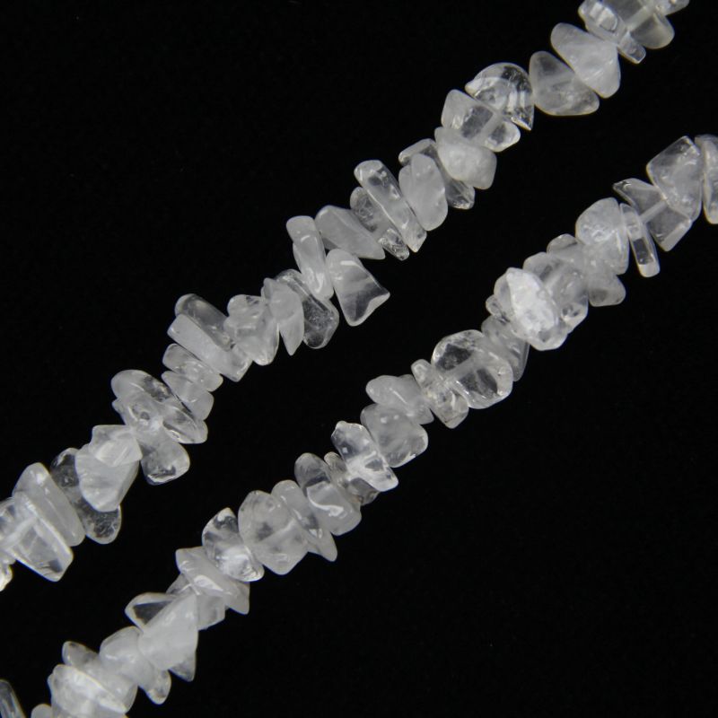 close-up of white cotton crystal irregular round beads showing natural cotton-like inclusions and nylon cord stringing, 5-8mm size