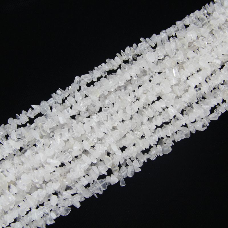 stacked coils of white cotton crystal bead strand, 31.5 inches long, irregular round 5-8mm beads on nylon cord
