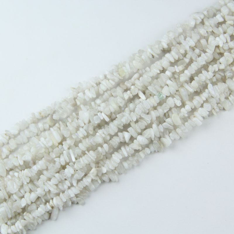 Multiple strands of natural white moonstone chip beads stacked together, showing 5-8mm irregular shape chips, bulk DIY jewelry supplies on wooden surface