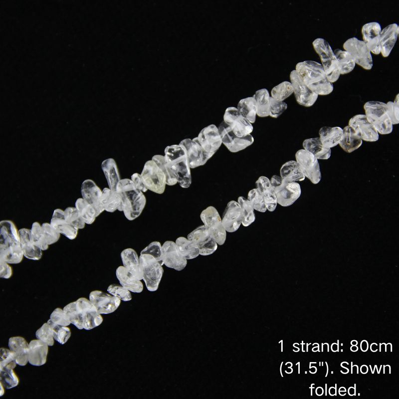 Macro close-up of white quartz chip beads, 5-8mm polished irregular chips with natural translucent clarity.