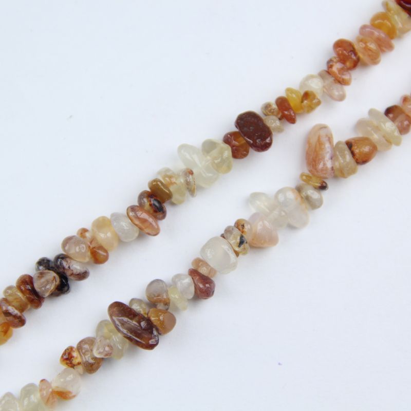 Close-up of natural yellow agate beads, showing honey yellow color, subtle banding, and slight translucency