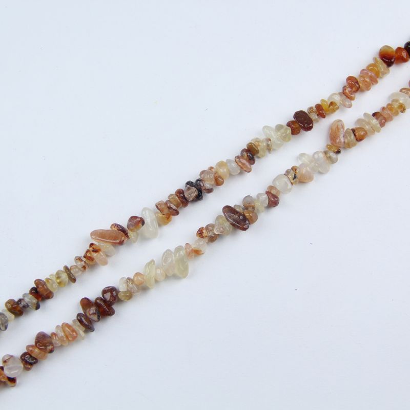 Single natural yellow agate irregular bead necklace laid flat on light surface, 31-inch length with organic round beads
