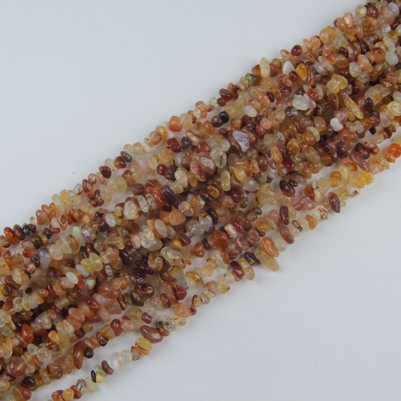 Multiple yellow agate long necklaces stacked together, showing warm honey yellow hues and slight color variation between strands
